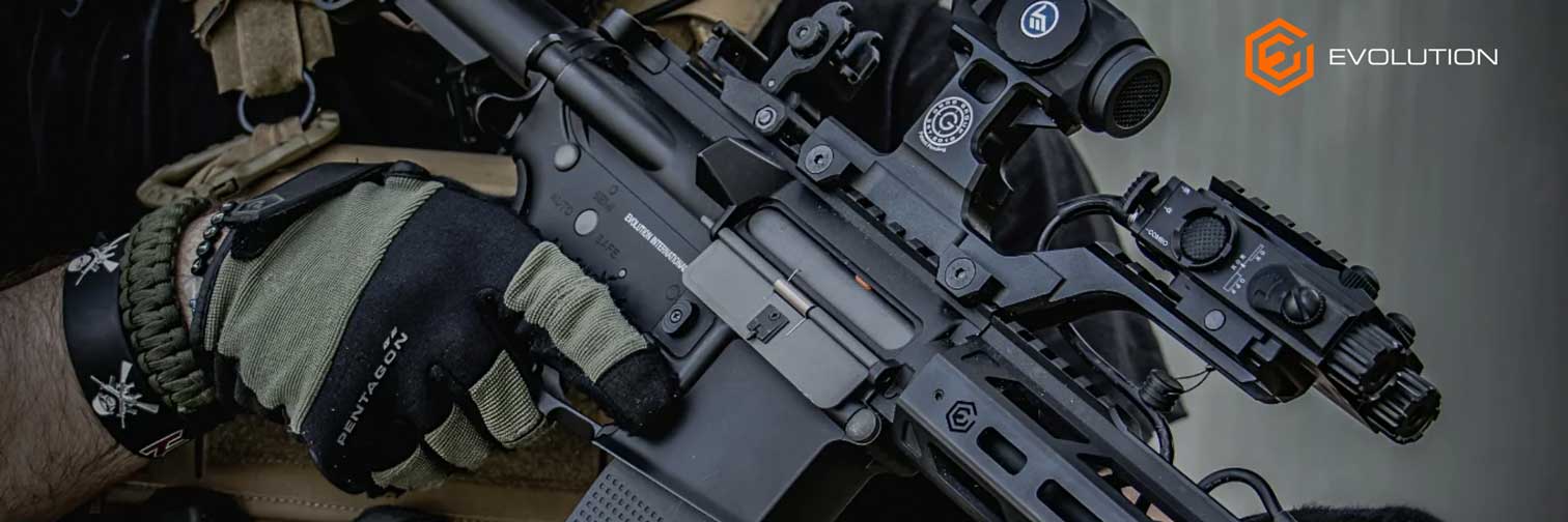 Close-up of a person holding a rifle with tactical gear, featuring the 'Evolution' logo.